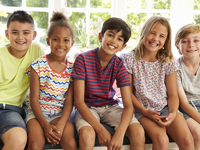 Group Of Multi-Cultural Children On Window Seat Together